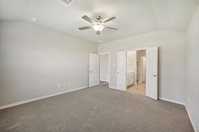 unfurnished bedroom featuring light carpet, lofted ceiling, and ceiling fan