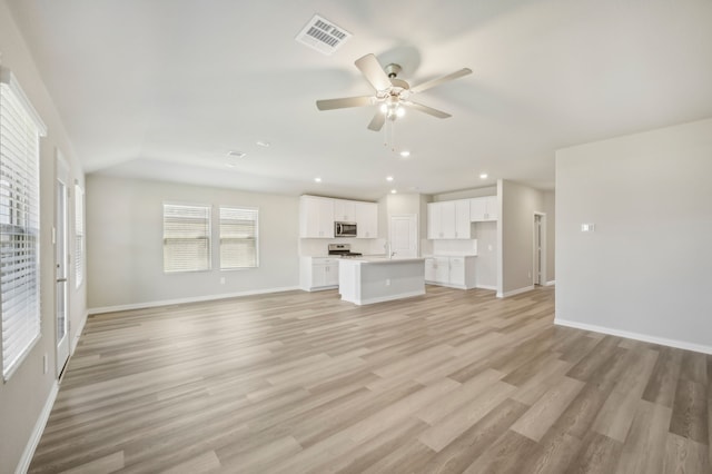 unfurnished living room featuring light hardwood / wood-style floors and ceiling fan