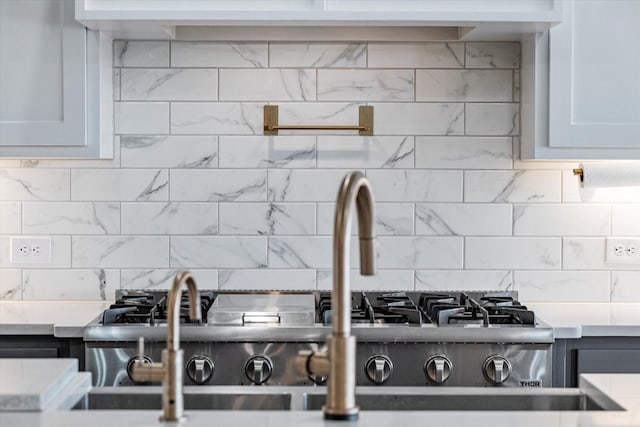 details with white cabinetry and tasteful backsplash