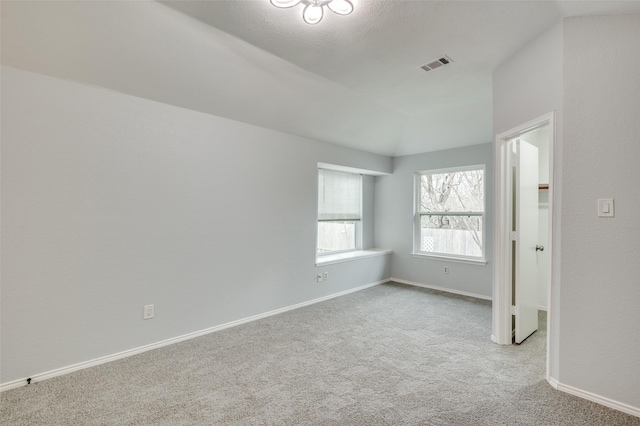 carpeted spare room featuring a textured ceiling