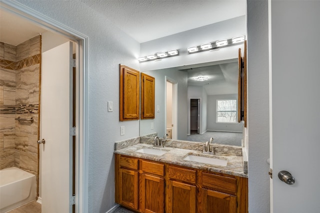 bathroom with vanity and tiled shower / bath combo