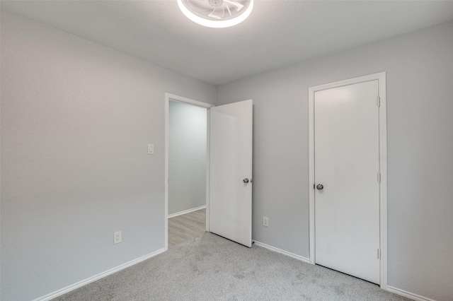 unfurnished bedroom with light colored carpet