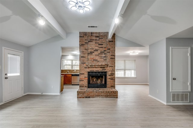 unfurnished living room featuring light hardwood / wood-style flooring, vaulted ceiling with beams, and a fireplace