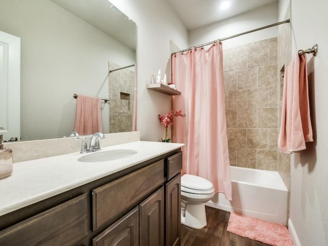 full bath featuring shower / bathtub combination with curtain, toilet, wood finished floors, baseboards, and vanity