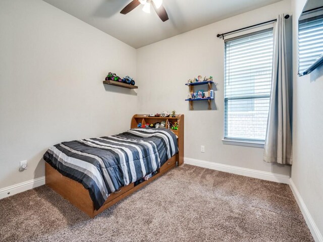 bedroom with baseboards, carpet floors, and a ceiling fan