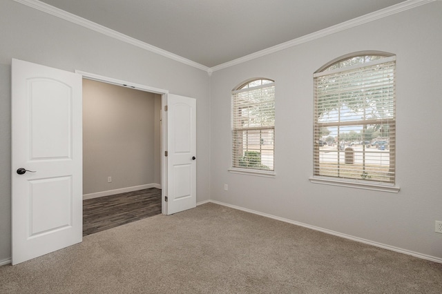 unfurnished bedroom featuring crown molding and carpet flooring