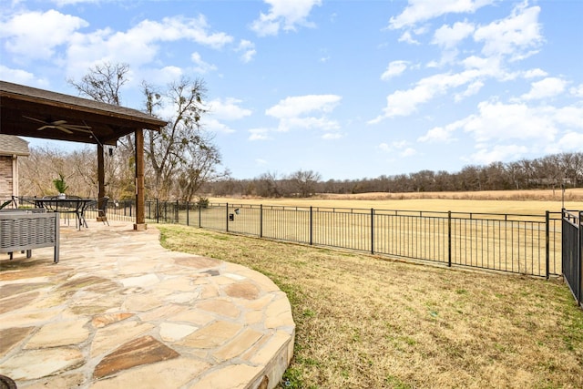 view of yard with a rural view and a patio