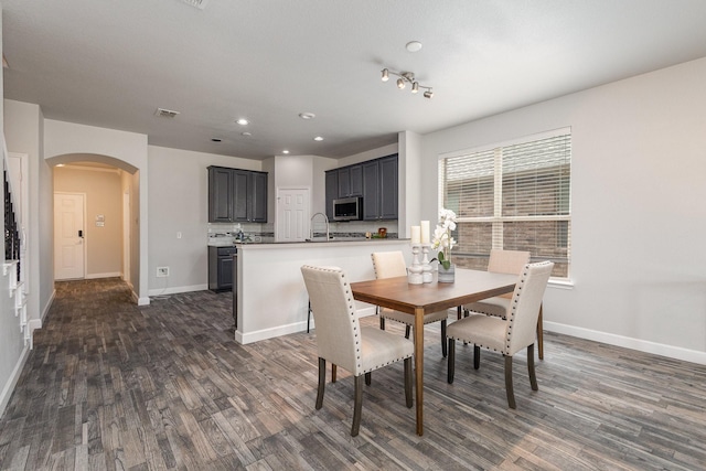 dining area with dark hardwood / wood-style flooring and sink