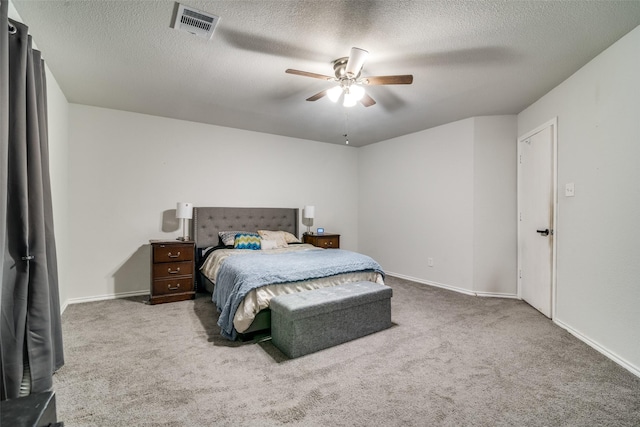 bedroom with carpet, a textured ceiling, and ceiling fan