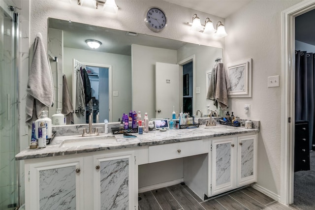 bathroom with vanity and walk in shower