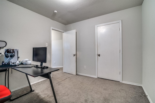 home office with light carpet and a textured ceiling