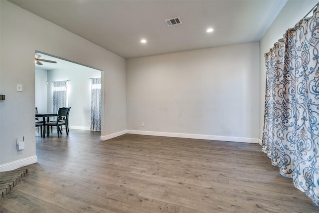 empty room with hardwood / wood-style flooring and ceiling fan