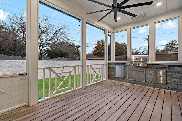 unfurnished sunroom featuring visible vents, a ceiling fan, and area for grilling