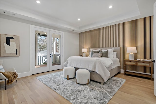 bedroom featuring access to exterior, baseboards, an accent wall, recessed lighting, and light wood-style flooring