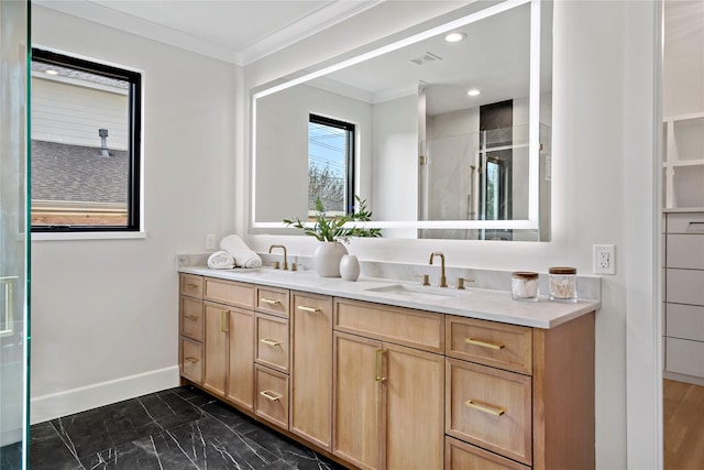 bathroom with a shower stall, ornamental molding, a sink, and marble finish floor