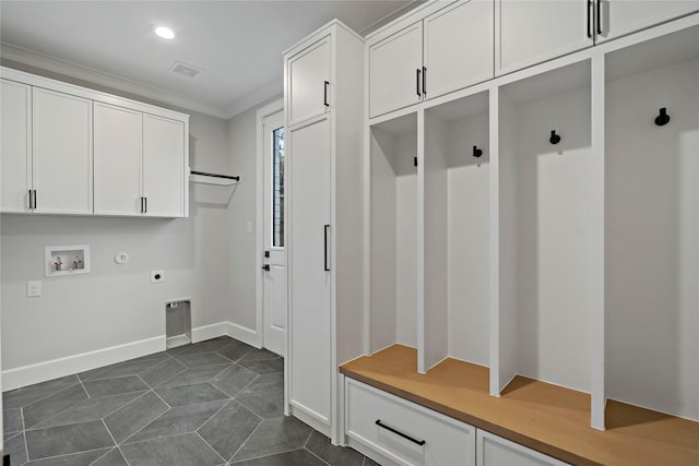 mudroom with crown molding and dark tile patterned floors