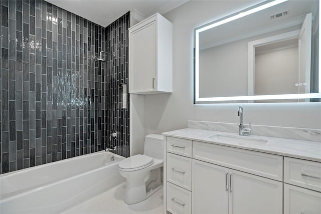 full bathroom featuring tiled shower / bath, vanity, and toilet