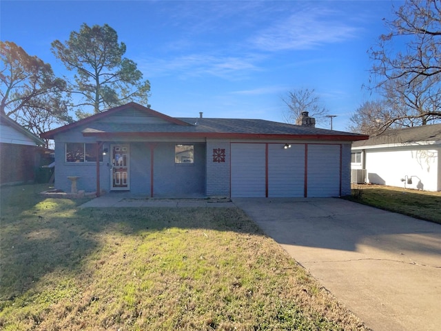 single story home with a garage, a front yard, and central AC unit