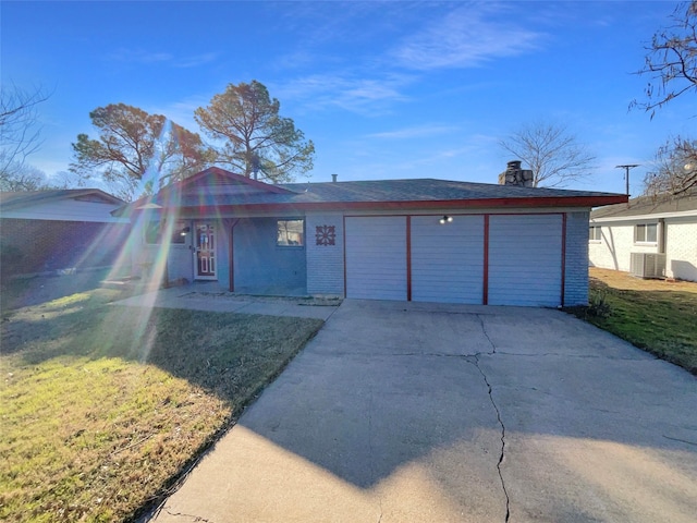 single story home featuring central AC unit, a garage, and a front lawn