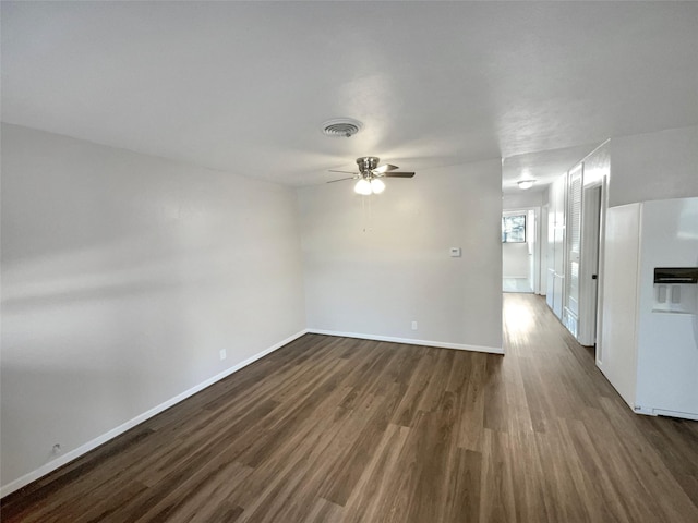 empty room featuring dark hardwood / wood-style flooring and ceiling fan