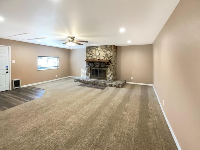 unfurnished living room featuring a fireplace, ceiling fan, and carpet flooring