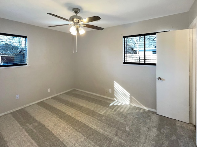 carpeted spare room with ceiling fan