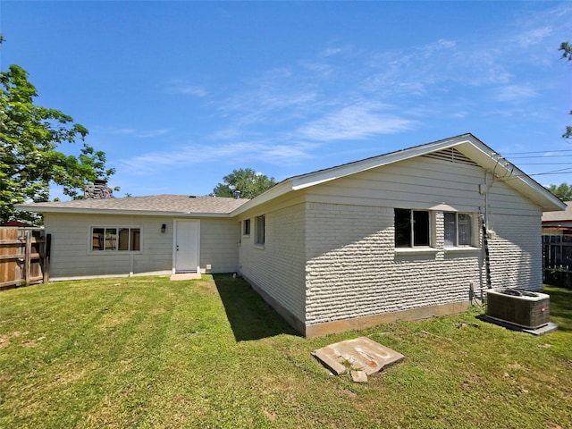 712 Brookfield Dr, Hurst, TX 76053 - back of property featuring brick siding, cooling unit, and a chimney