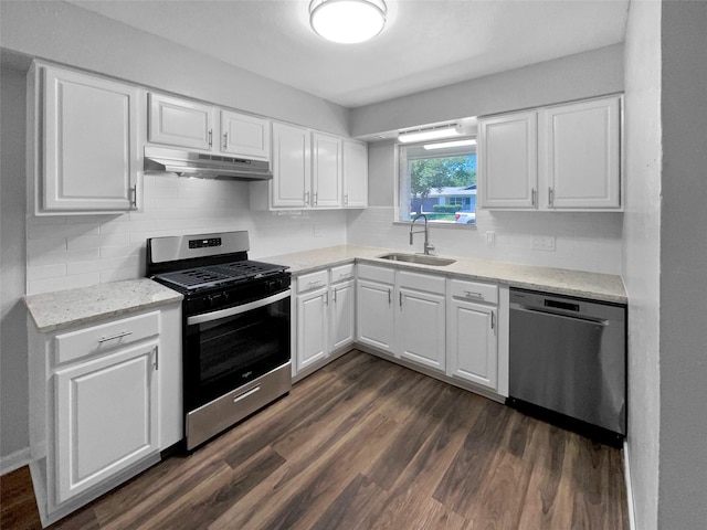 712 Brookfield Dr, Hurst, TX 76053 - kitchen with stainless steel appliances, under cabinet range hood, a sink, dark wood-style floors, and white cabinetry