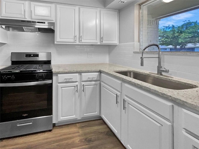 712 Brookfield Dr, Hurst, TX 76053 - kitchen featuring stainless steel range with gas stovetop, under cabinet range hood, a sink, and white cabinetry