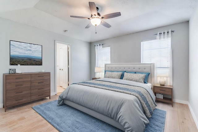 bedroom featuring ceiling fan, ensuite bathroom, and light hardwood / wood-style floors