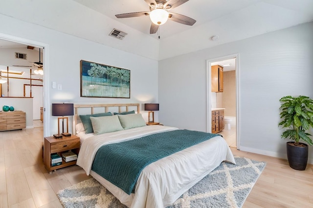 bedroom featuring lofted ceiling, light hardwood / wood-style flooring, ceiling fan, and ensuite bathroom