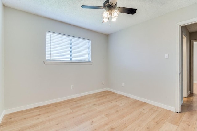 empty room with ceiling fan, a textured ceiling, and light hardwood / wood-style floors