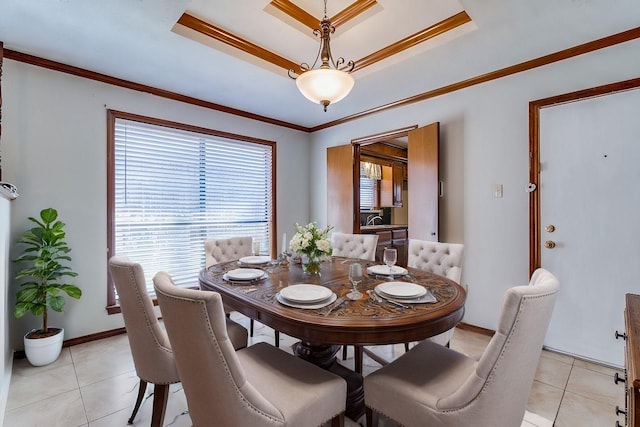 dining area featuring crown molding, a raised ceiling, and light tile patterned floors