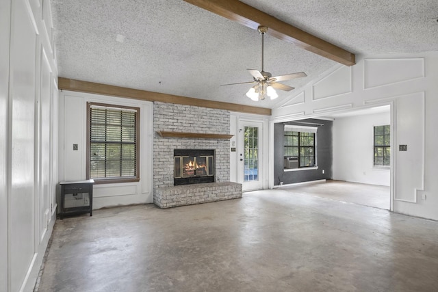 unfurnished living room with a wealth of natural light, concrete floors, and a textured ceiling