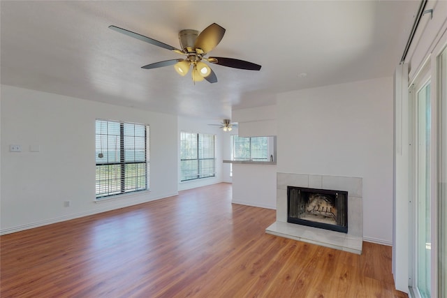 unfurnished living room featuring a fireplace and light hardwood / wood-style floors