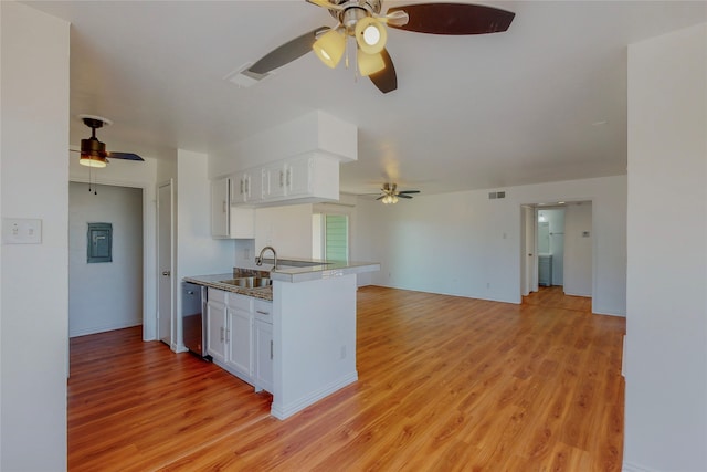 kitchen with sink, light hardwood / wood-style flooring, stainless steel dishwasher, kitchen peninsula, and white cabinets