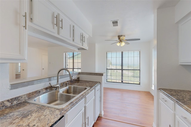 kitchen featuring sink, white cabinetry, kitchen peninsula, ceiling fan, and light hardwood / wood-style floors