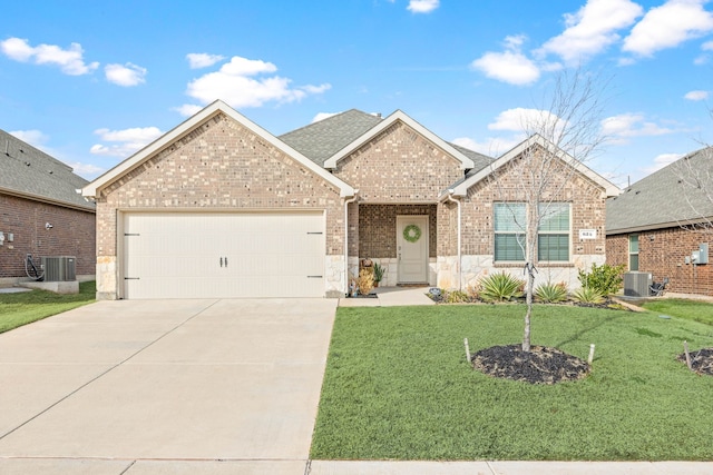 view of front of home with a garage, central AC, and a front yard