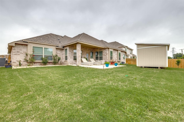 back of house featuring a patio, a storage unit, central AC unit, and a lawn