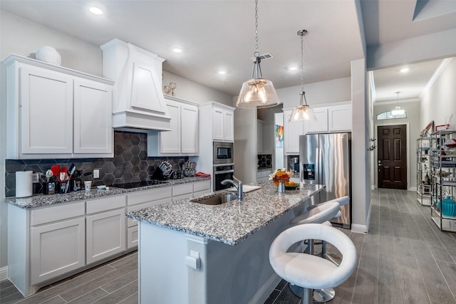 kitchen featuring pendant lighting, appliances with stainless steel finishes, custom exhaust hood, and white cabinets