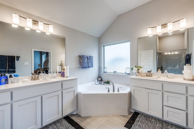 bathroom featuring lofted ceiling, vanity, tile patterned flooring, and shower with separate bathtub