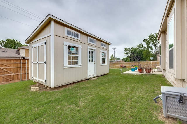 view of outbuilding featuring a lawn