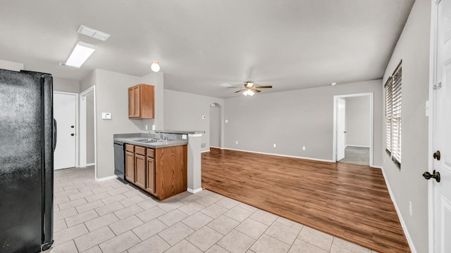 kitchen featuring sink, light tile patterned floors, black appliances, and ceiling fan