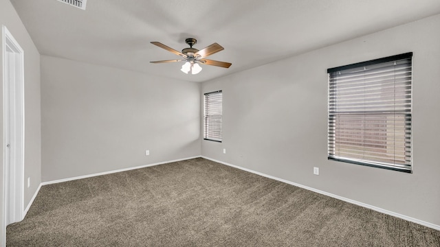 empty room featuring ceiling fan and carpet floors