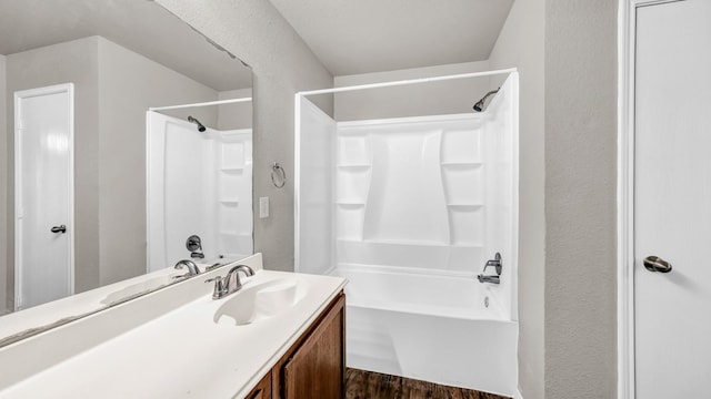 bathroom with vanity, hardwood / wood-style flooring, and shower / bath combination