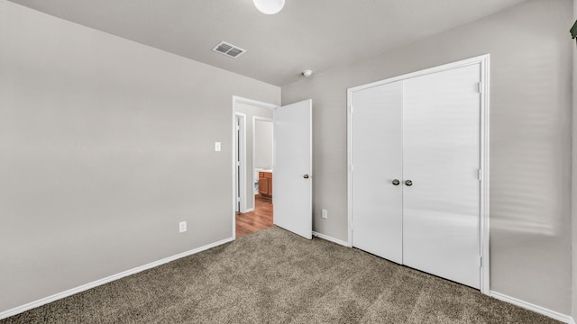 unfurnished bedroom featuring carpet floors and a closet