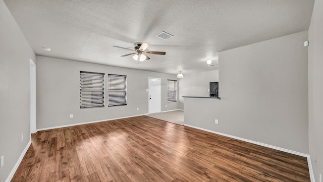 unfurnished living room with hardwood / wood-style flooring, ceiling fan, and a textured ceiling