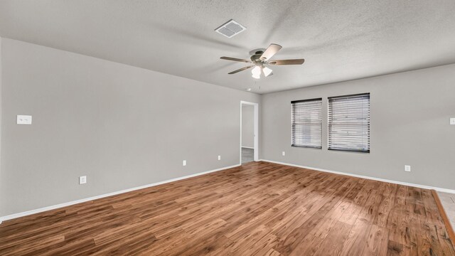 empty room with hardwood / wood-style floors, a textured ceiling, and ceiling fan