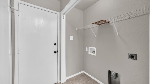 laundry area with electric dryer hookup, light tile patterned floors, and hookup for a washing machine