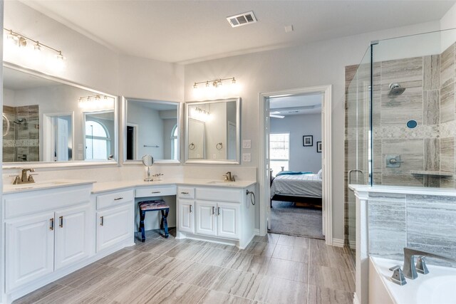 carpeted bedroom featuring a tray ceiling and ceiling fan